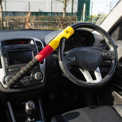 Automatic steering wheel lock physical barrier